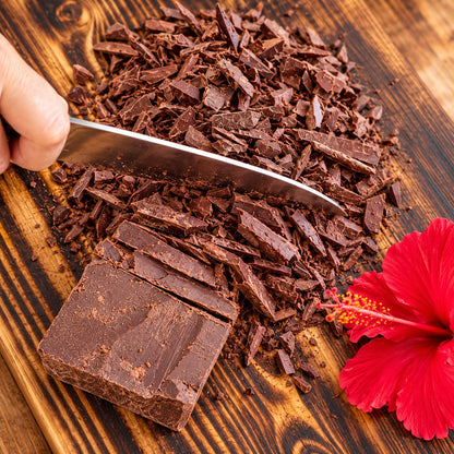 Cutting a block of ceremonial cacao into chunks [1 bag (450g); 1kg bag; 10 bags (450g); 30 bags (450g); 60 bags (450g); 5kg block; 25kg (in 5kg blocks); 75kg (in 5kg blocks)]