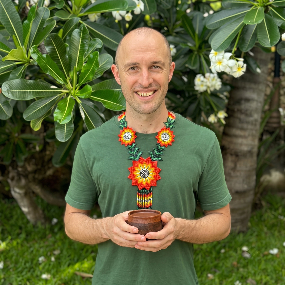 Gavin holding ceremonial cacao in the garden [1 bag (450g); 1kg bag; 10 bags (450g); 30 bags (450g); 60 bags (450g)]